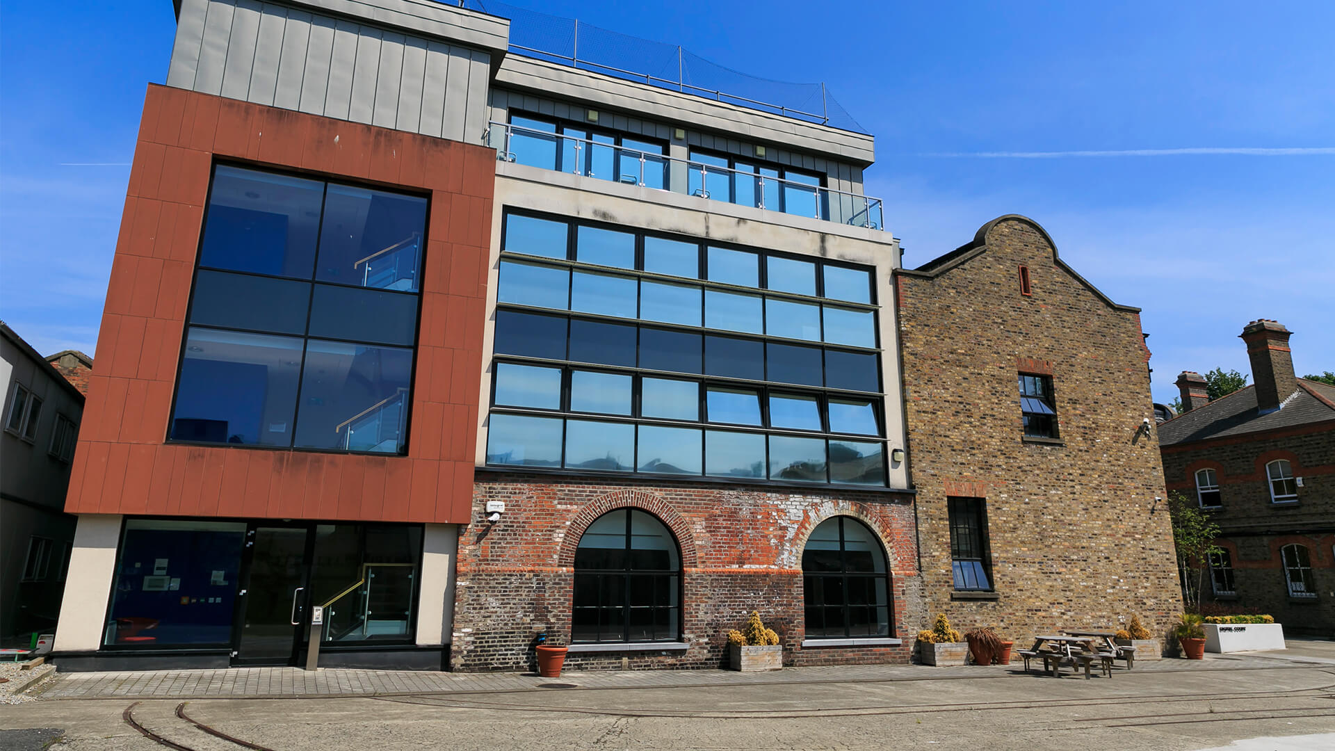 New meets old in the Digital Court, where a sleek modern extension is joined to the old industrial brick building