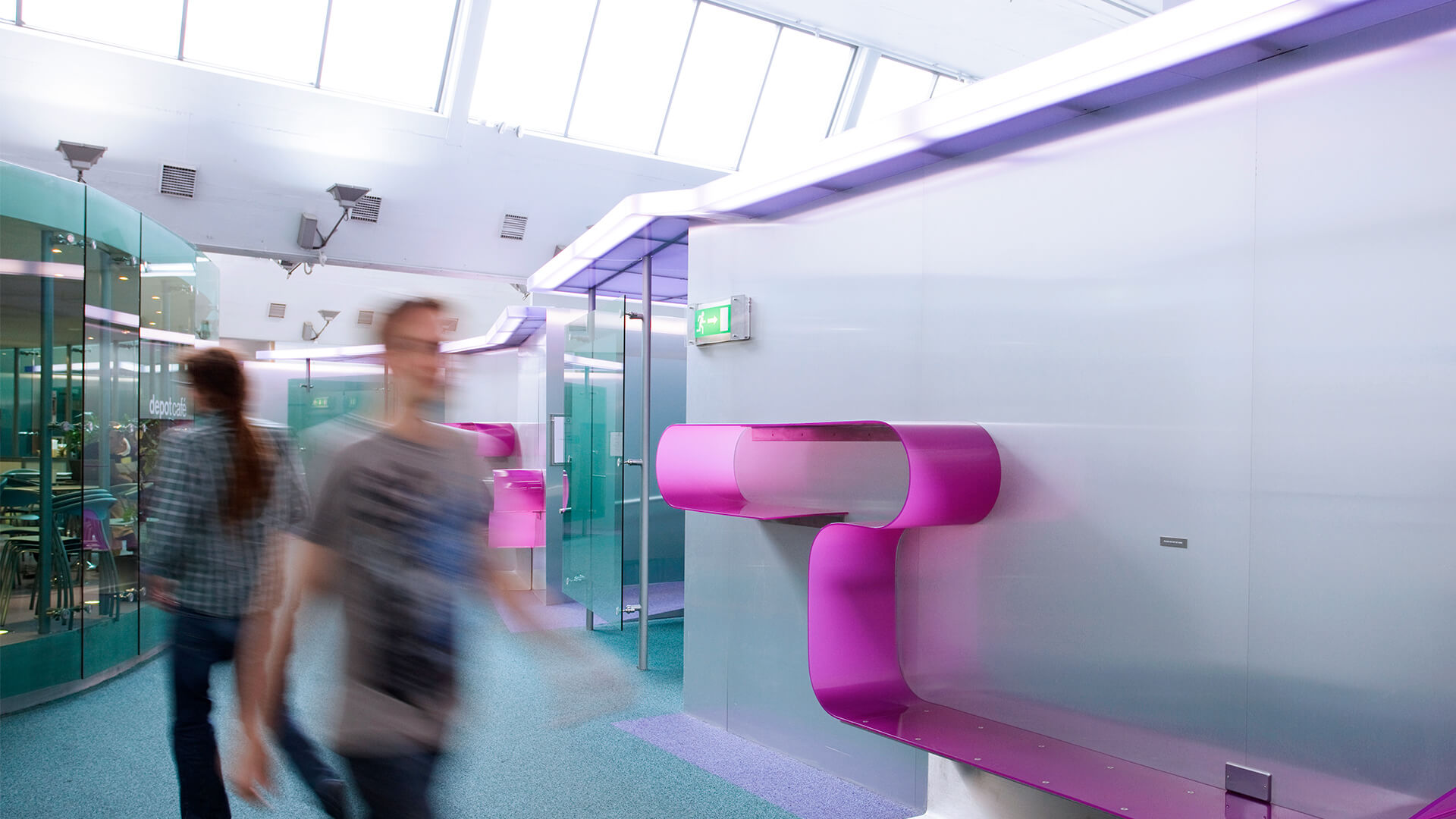 People in blurred motion walk through the modern, light-filled Digital Depot building