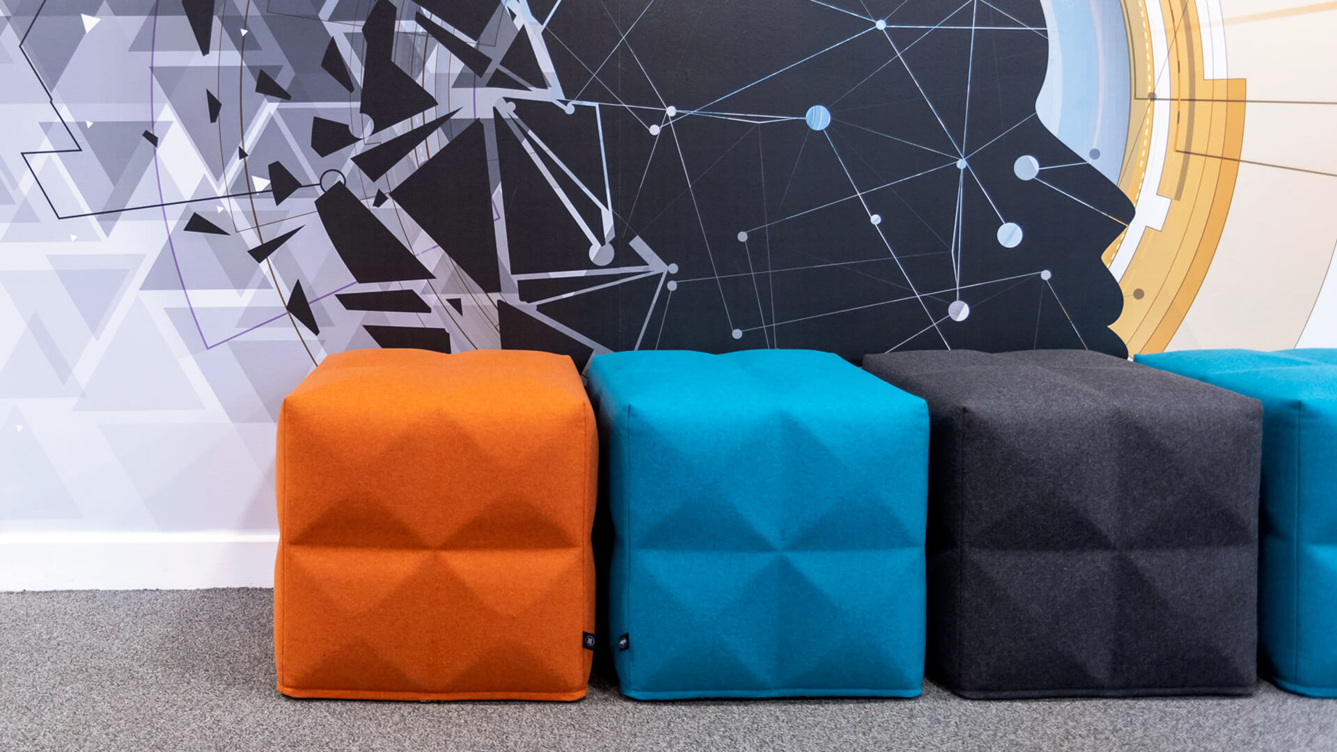 Detail of geometric cube seating in shades of orange, blue and grey