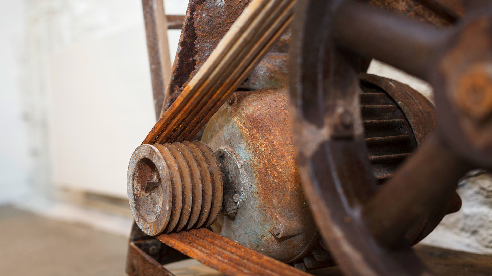 A close-up of the cogs and wheels of old machinery from the building's industrial past
